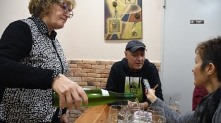 Pascual serveix copes de vi mentre Sílvia Culell entrevista Jordi Martínez al bar 103.